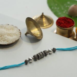 String of silver manis rakhi